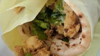 Chicken Shawarma Sandwich · Chicken, romaine lettuce, tomatoes, onions, and tahini sauce. Rolled in a pita.