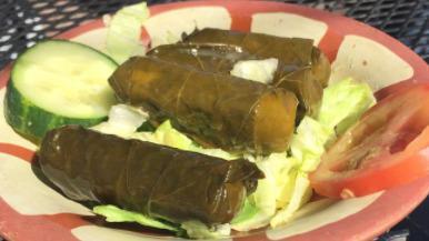 Dolmathes Entrée · Four grape leaves stuffed with wild rice in zesty olive oil with hummus and salad. Served with pita.