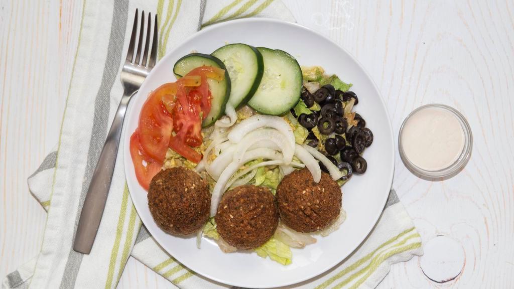 Falafel Salad · Falafel, romaine lettuce, tomatoes, cucumbers, red onions, olives, and house dressing.