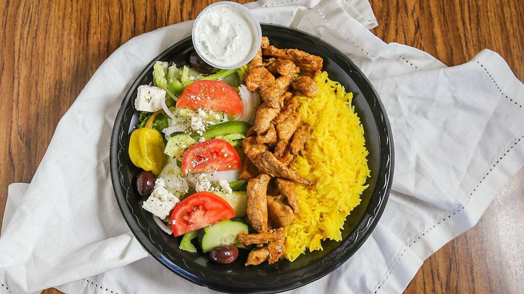 Chicken Shawarma Dinner · Freshly chopped chicken breast, marinated in our secret blend of herbs and spices.  Grilled until tender and moist served with our aromatic basmati rice, greek salad, garlic sauce, and pita bread.