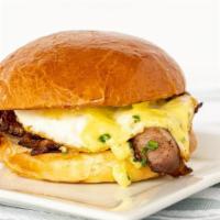 Friends With Benedicts · smoked bacon, local cage free runny egg scratch hollandaise served in a toasted brioche bun