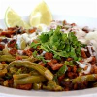 Choriqueso · Spicy pork sausage and spicy pork meat and nopales with melted cheese. Served with 6 corn to...