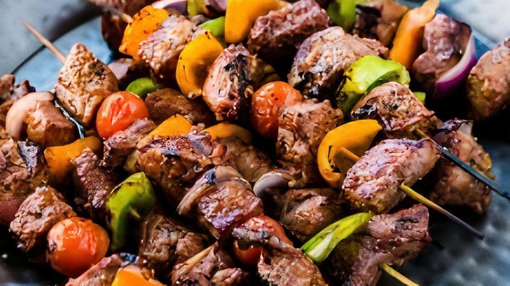 Beef Shish Kabob · Flap meat, seasoned and grilled. Served with a side of rice or potatoes(tossed in olive oil, dill and garlic), house sauce, hummus and onions and greens mix.
