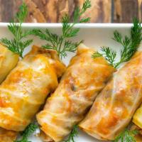 Stuffed Cabbage · (4)Cabbage stuffed with ground beef, rice, cilantro and onions slow cooked. Served with sour...