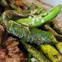 Carne Asada · Marinated & grilled steak with cantina beans (contains pork), red rice, roasted chilies, gri...