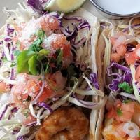 Shrimp Tacos (2) · Shrimp sauteed in spicy coconut-chipotle sauce, smoked onions, cabbage, cotija, pico de gall...