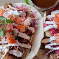 Carnitas Tacos (2) · Traditional citrus, guajillo & garlic-braised pork with caabbage, pickled red onions, pico d...