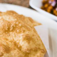 Chole Batura · Deep fried puffed white flour bread, served with garbanzo beans cooked in onion and tomato s...