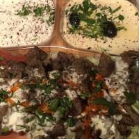 Lamb Shanks · lamb shanks, rice, hummus, tzatziki, salad, garlic sauce,  and pita bread