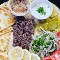 Kebab Plate · kebab, rice, salad, tzatziki, hummus, and pita bread
hot sauce and garlic sauce on the side
