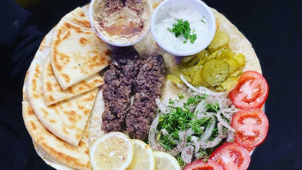 Kebab Plate · kebab, rice, salad, tzatziki, hummus, and pita bread
hot sauce and garlic sauce on the side
