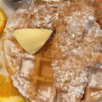 Chicken ‘N Waffle · Golden delicious Belgian waffle topped with our succulent breaded and boneless chicken breas...