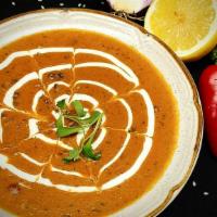 Dal Makhani · Slow cooked creamy mixed lentils.