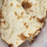 Naan · White bread prepared from the golden flame of a clay oven.