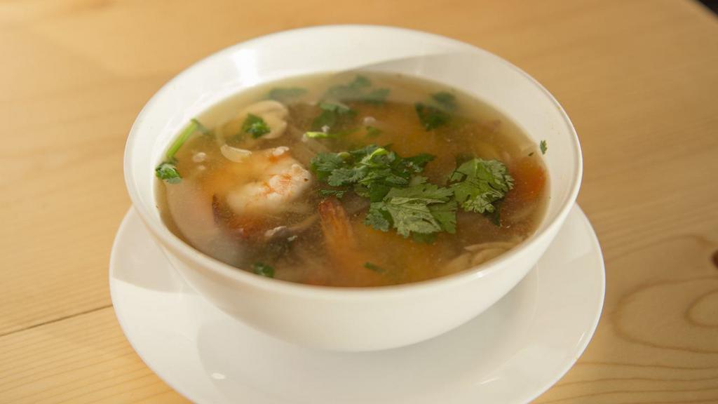 Tom Yum Soup · Gluten free. Spicy and sour soup (chicken broth) with mushroom, onion, tomato, galangal, lemongrass, kaffir lime leaves, and cilantro.