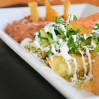 #4 Enchiladas · 4 enchiladas chicken or beef on layered corn tortillas in a green sauce with white cheese an...