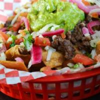 Ricos Nachos (Choice Of Meat) · Corn chips with cholesterol free beans, pico de gallo, monterrey jack cheese topped with gua...