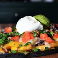 Carne Asada Fries · French fries, carne asada steak, and melted 
cheese. Served with guacamole, pico de gallo 
a...