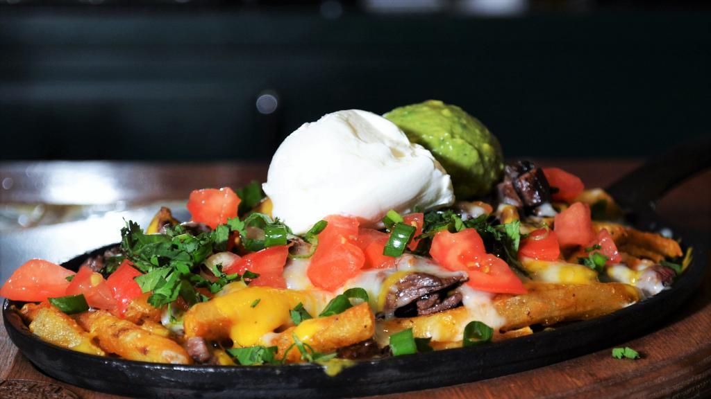 Carne Asada Fries · French fries, carne asada steak, and melted 
cheese. Served with guacamole, pico de gallo 
and beans.