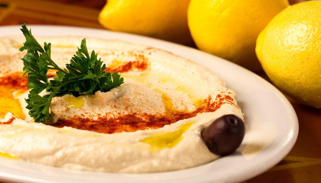Hummus · Vegan. Gluten free. A puree of chickpeas, tahini, fresh garlic, olive oil, and fresh lemon juice.