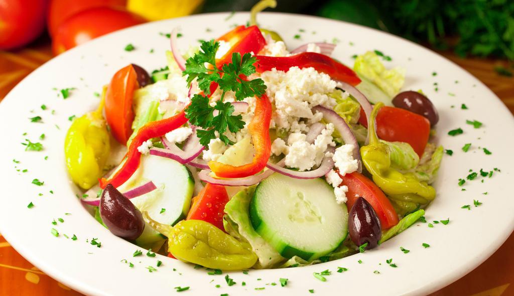 Greek Salad · Vegetarian, vegan without feta cheese. Gluten free. A large bed of romaine lettuce topped with fresh vegetables, Greek feta cheese, and Greek olives. Finished with paymon's famous Greek dressing.