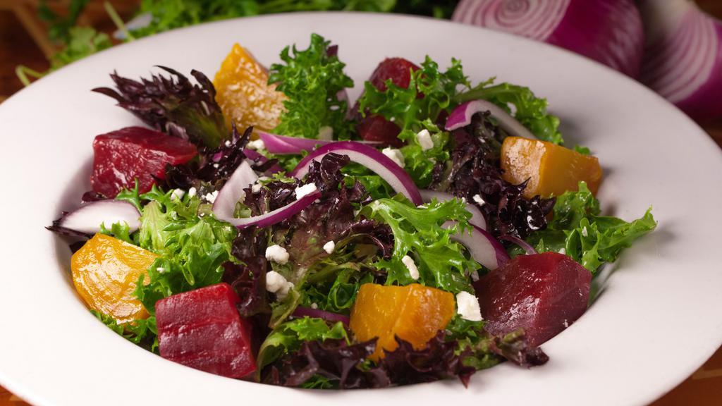 Roasted Beet Salad · Vegetarian, vegan without goat cheese. Gluten free. Roasted red and golden beets, mixed greens, red onions, walnuts, and Goat cheese tossed in a pomegranate vinaigrette dressing.