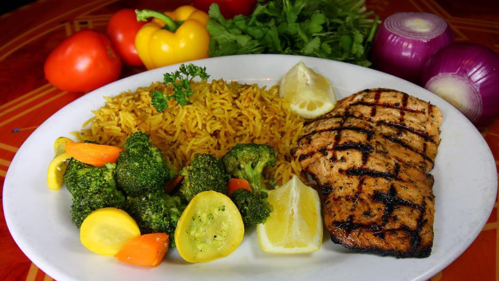 Grilled Salmon · Mediterranean spiced salmon, and char-grilled. Served with sautéed vegetables and vermicelli pilaf.