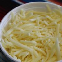 Cheese 8 Oz Cup · 8 OZ Of white Monterrey shredded Cheese
