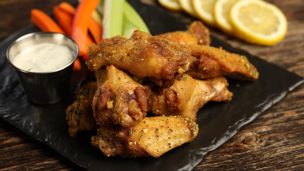Traditional Lemon Pepper · 8 lemon pepper wings, served with carrots & celery and a choice of blue cheese or ranch for dipping (mild heat)