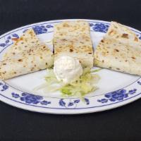 Quesadilla · flour tortilla with cheese, your choice of meat , onion, and  cilantro, served with sour cream