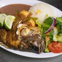Mojarra Rellena De Camaron · Fried tilapia filled with shrimp, served with rice, beans and salad.