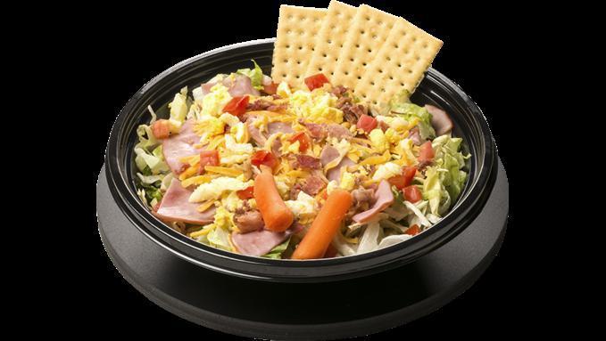 Chef Salad · Lettuce, Diced Ham, Cheddar Cheese, Bacon, Diced Tomatoes, Diced Eggs with a side of Carrots and Crackers.