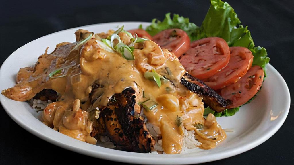 Smothered Catfish (Dinner) · Blackened catfish fillets (2) smothered with our mildly spicy crawfish cream sauce, served over rice or pasta with tomatoes vinaigrette on the side