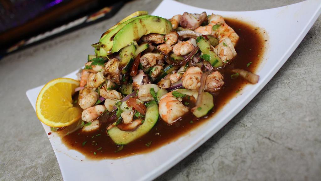 Ceviche Mixto · Cured shrimp and fish, octopus, scallops, sumerge and special sauce, tomatoes, onion, cucumber, cilantro, avocado.