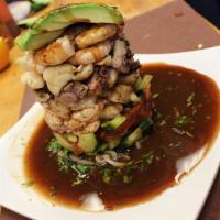 Mariscotower  · Cured and coolked shrimp scallops, octopus, fish, onion, tomatoes cucumbers, avocado and spe...