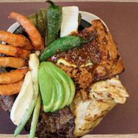 Molcajete Coco · Steak, marinated pork, grilled chicken, shrimp, chorizo, cactus, avocado, Mexican fresh chee...