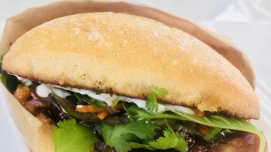 Hercules Banh Mi · Thai glazed tempeh stacked with fresh cilantro, mint, basil, house pickled cucumber and carrot, fresh jalapeno and spicy aioli all on a toasted ciabatta bun.