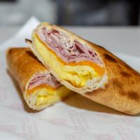 Breakfast Burrito · Ham, double eggs, cheddar and breakfast sauce in a whole wheat wrap.