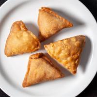 Vegetable Samosa · Crisp pastry filled with potato, peas, spices and deep fried.