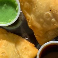 Meat Samosa · Crisp pastry filled with ground lamb and chicken, peas, spices and deep fried.