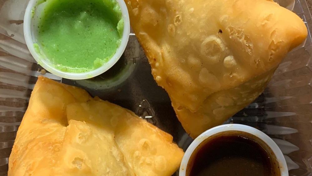 Meat Samosa · Crisp pastry filled with ground lamb and chicken, peas, spices and deep fried.