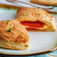 Pepperoni And Mozzarella Calzone · Lots of Pepperoni and Mozzarella cheese stuffed and folded inside Pizza Dough. Served with M...
