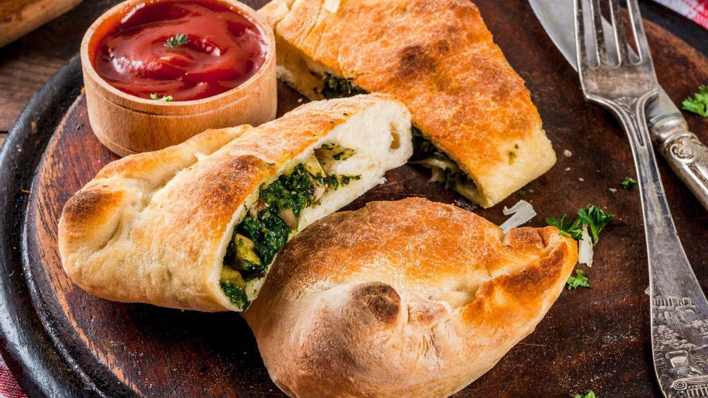 Spinach And Mozzarella Calzone · Spinach and Mozzarella cheese stuffed and folded inside Pizza Dough. Served with Marinara sauce.