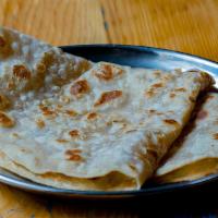 Paratha · Layered Indian flatbread with ghee.