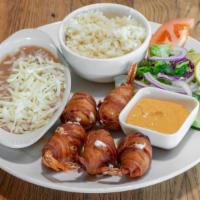 Momias · Bacon Wrapped Shrimp stuffed with  Cream Cheese served with Beans and Rice