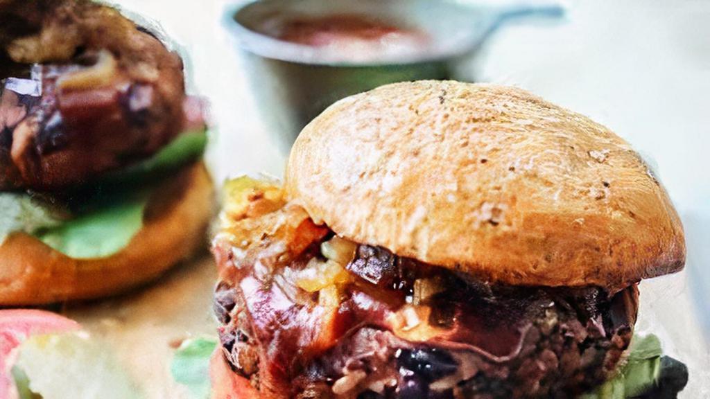Vegan Bbq Burger · Vegan plant based burger patty with vegan cheese, caramelized onions, and BBQ sauce on a toasted bun.