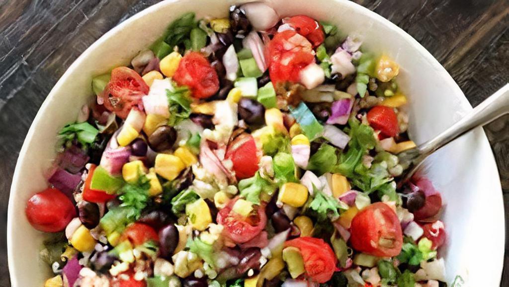 Quinoa Black Bean Salad · A salad of lettuce, black beans, quinoa, and tomatoes.