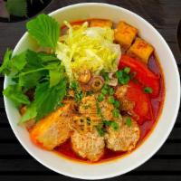 Bun Rieu · Shrimp cake, pork meatball, tofu, tomato, rice noodle vermicelli, onion, herb, broth, black ...