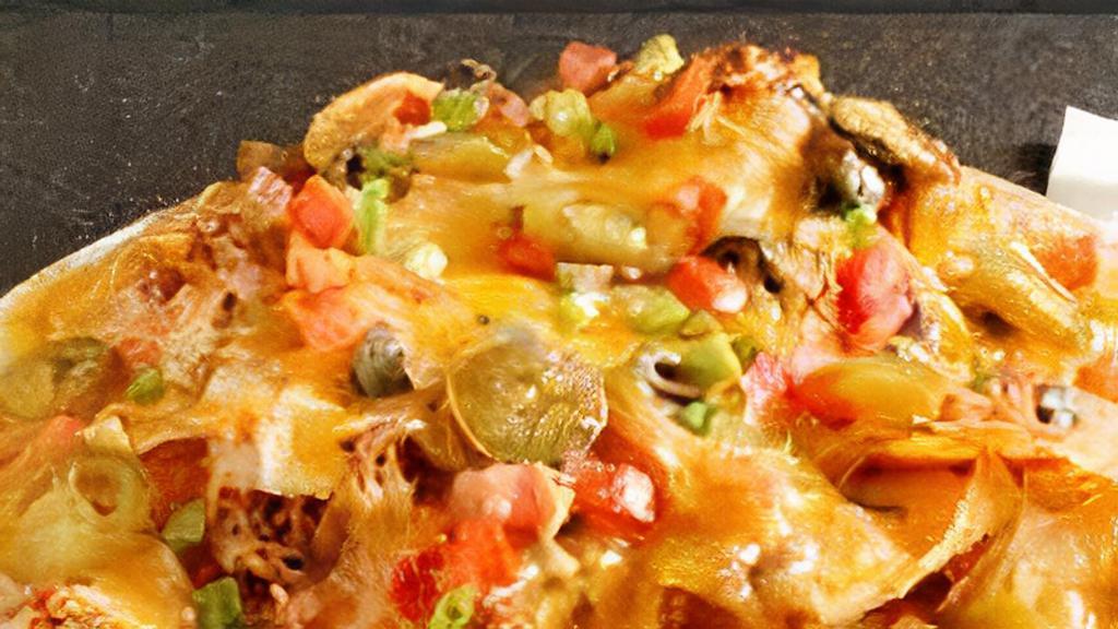 Macho Nachos · Cheddar and jack cheese melted on fried tortilla chips topped with pinto beans with jalapeno slices, pico De gallo, guacamole and sour cream.