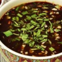 Manchow Soup (Veg) · Indo Chinese favorite, chicken, sauteed ginger, garlic, and soy broth topped with crispy noo...